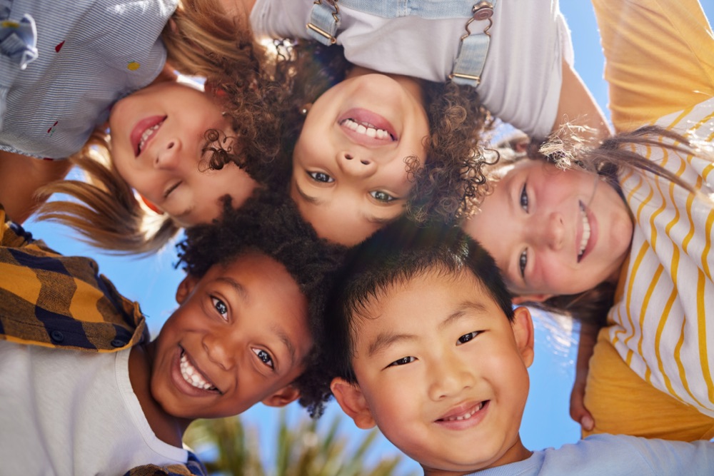 Smiling children looking down into the camera